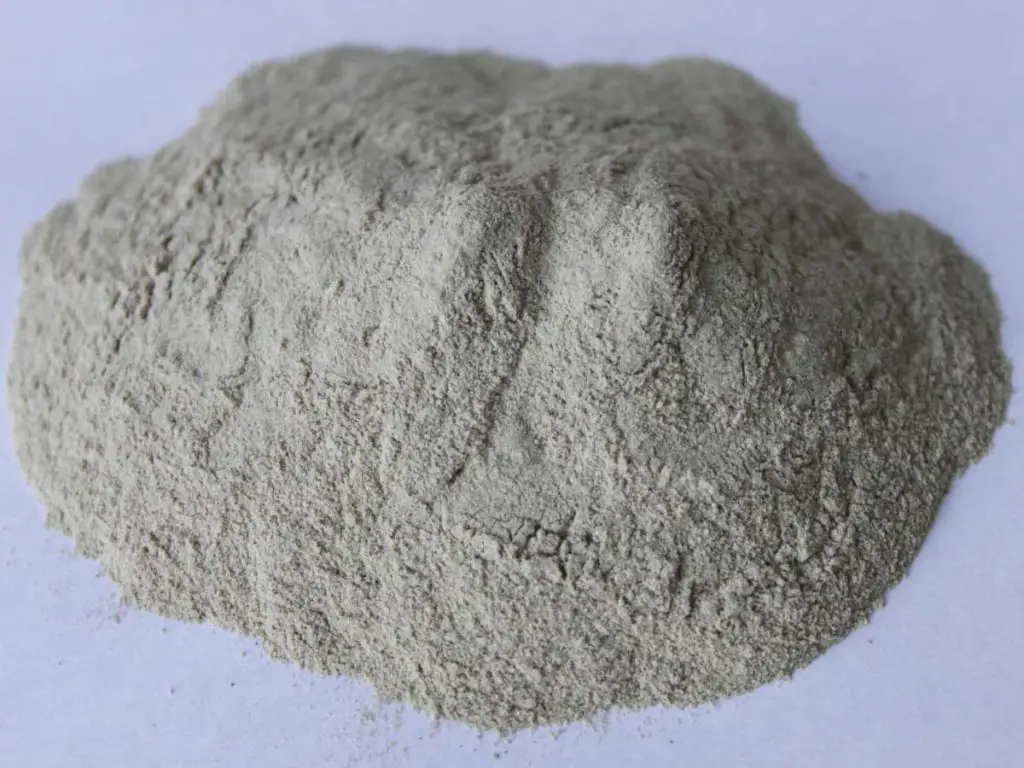 A grey pile of dried clay powder used in a Koi pond for health benefits.