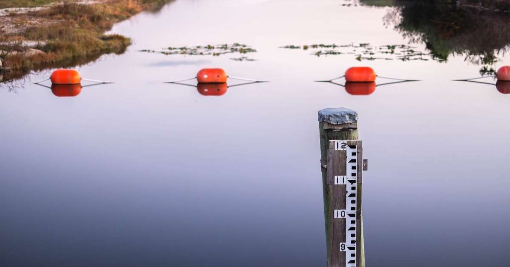 A depth meter in a pond to measure how deep it is.